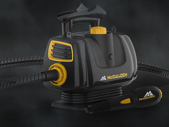 Mcculloch MC1270 portable power steam cleaner with insulated hose on a black background with steam visible in the background. Visible carry handle and heat indicator light